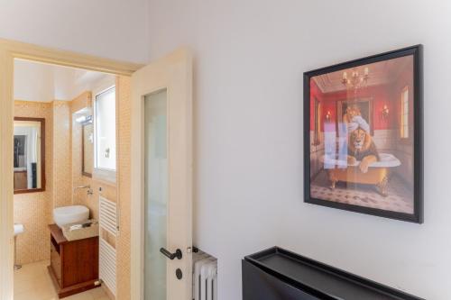 a bathroom with a picture on the wall at Sempione Color Milano CityLife Fiera District in Milan