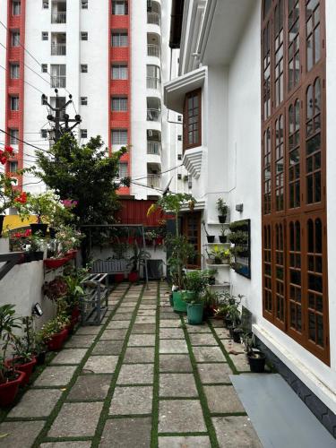 a courtyard of a building with potted plants and buildings at Metro Bliz Alua by thestaypoint in Alwaye