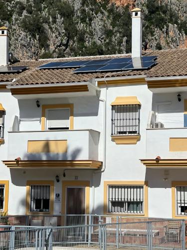 a building with solar panels on the roof at Casa Rural las Rosas de Benaojan in Benaoján