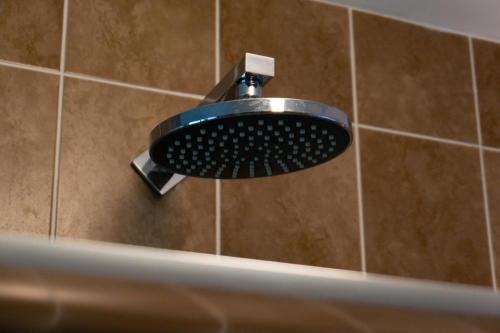 a bathroom sink in a shower with a faucet at Sheelin Lake House in Cavan