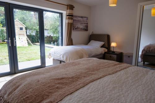 a bedroom with two beds and a large window at Sheelin Lake House in Cavan
