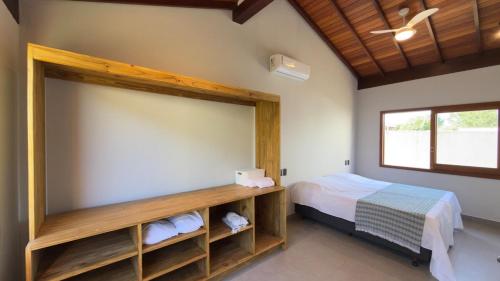 a bedroom with a bed and a large window at Villa 4 Elements, Studios Praia de Saquaíra, Maraú in Marau