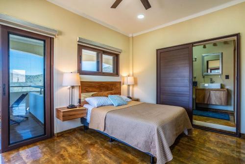 a bedroom with a bed and a large window at Pent house in Cabo Pulmo