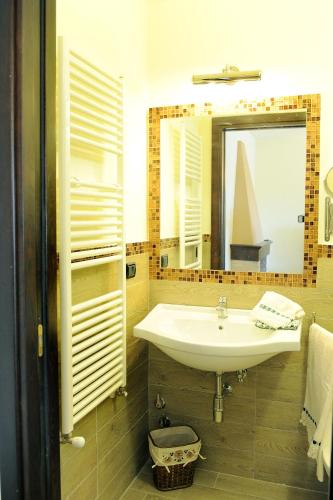 a bathroom with a sink and a mirror at Residence Les Amis in Castel di Sangro