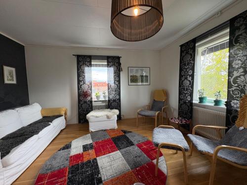 a living room with a bed and a rug at Lägenhet centralt i Mora in Mora