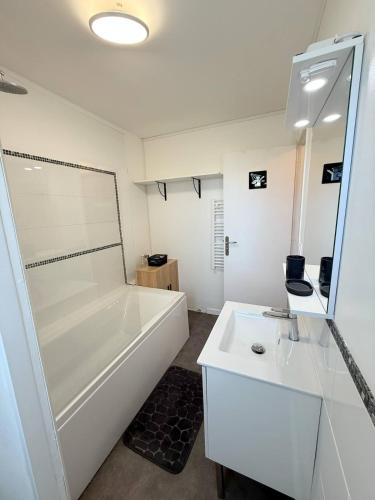 a bathroom with a shower and a tub and a sink at Studio, sea side in Berck-sur-Mer
