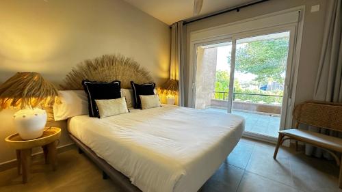 a bedroom with a bed and a large window at Moraira Ritual de Terra By Elconserje in Moraira