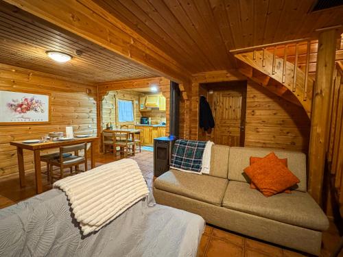a living room with a couch in a log cabin at Chalé do Zêzere in Cortes do Meio