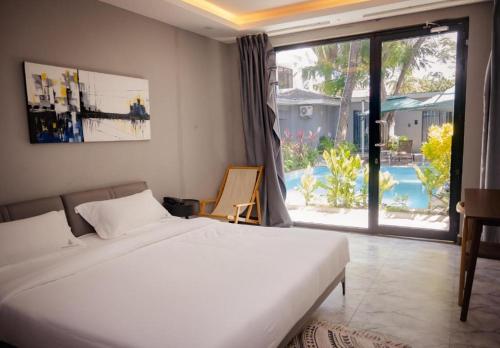 a bedroom with a bed and a view of a pool at The L Boutique Tz in Dar es Salaam
