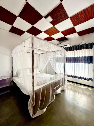 a bedroom with a canopy bed in a room at The horezt in Kamburugamuwa