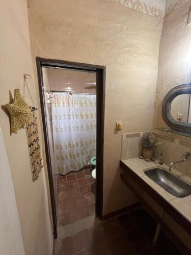 a bathroom with a sink and a shower at Casa Paso in Paso de la Patria