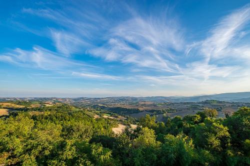 a view of a valley with trees and a blue sky at Casa Oliva borgo del Benessere Olistico in Bargni