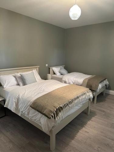 two beds sitting in a room with at Clare Cottage in Doolin