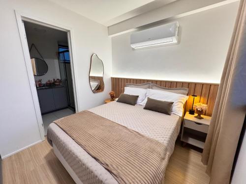 a bedroom with a large bed with two pillows at Refúgio Serena in Niterói