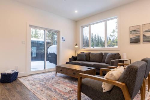 a living room with a couch and a table at Powder House Chalet by Fernie Central Reservations in Fernie