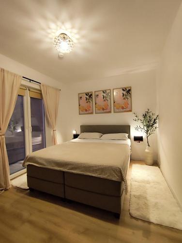 a bedroom with a bed and a window at Casa Nova in Njivice