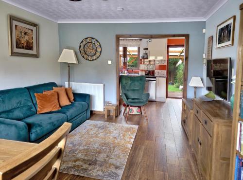 a living room with a blue couch and a table at A cosy house near the city centre in Glasgow