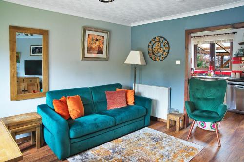 a living room with a blue couch and a chair at A cosy house near the city centre in Glasgow