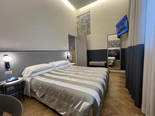 a hotel room with a bed and a mirror at Hotel Il Sole in Empoli