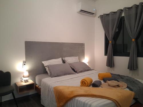 a bedroom with a bed with two stuffed animals on it at charmante maison in Les Avirons