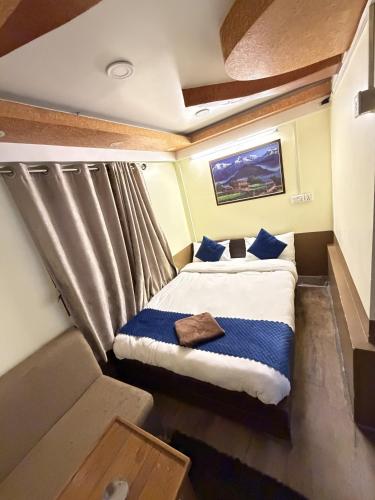 a small bed in a small room with a window at Hotel Sakura & Tandoori Restaurant in Kathmandu