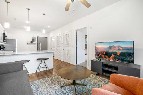 a living room with a couch and a tv at 1B1B Midtown Apartment Private Balcony, Views, Gym - 6 in Atlanta