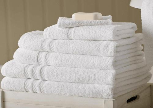 a stack of towels sitting on top of a dresser at Charming Heritage Townhouse in Odense