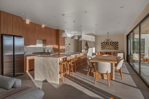 a kitchen and dining room with a table and chairs at Pool - Spa - Fire pit - Views - BBQ - Bella Nova in Joshua Tree