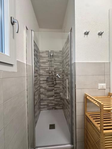 a shower with a glass door in a bathroom at Casa Aniste in Castelsardo