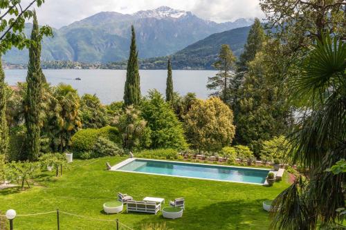 a swimming pool in a yard with a lake and mountains at Villa Artemisia by MyVillaCollection in Lenno