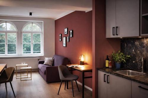 a kitchen and living room with a couch and a table at Brera Leipzig in Leipzig