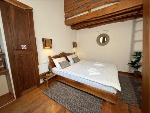 a small bedroom with a bed with a wooden frame at Vista Rustic Room in Sibiu