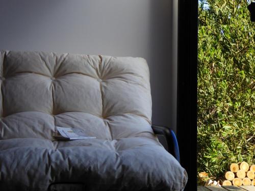 a white couch sitting in front of a window at Pretas in Punta Del Diablo