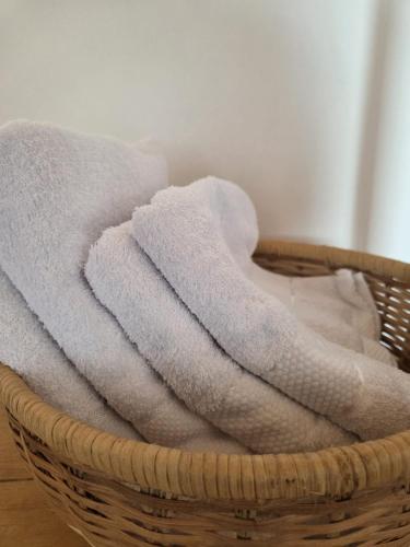 a basket filled with white towels in a room at SEED-Aeroport Nsimalen Yaounde in Nsimalen