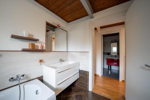 a bathroom with a white sink and a mirror at Urban Nest in Forlì