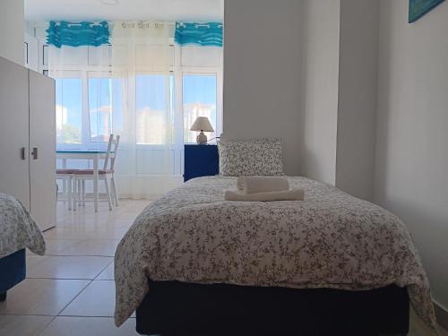 a bedroom with a bed and a table and chairs at Casa do Luiz in Lisbon