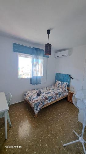 a bedroom with a bed in a room with a window at Carmen Guest House in Benalmádena