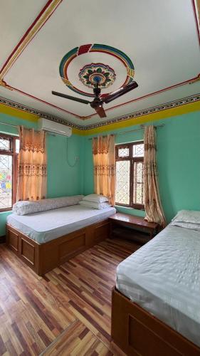 two beds in a room with green walls at Hotel lalu in Rāmechhāp