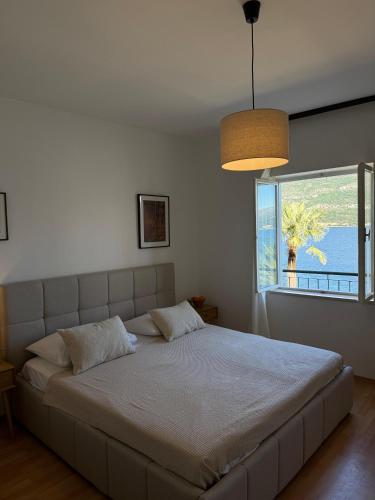 a bedroom with a large bed with a large window at The Korčula Outlook - Bedrooms in Korčula