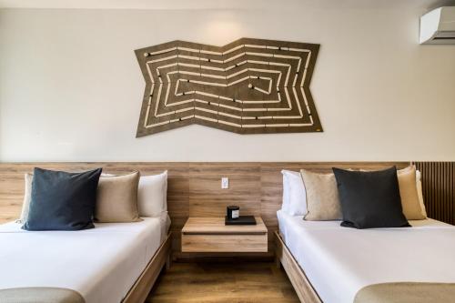 two beds sitting next to each other in a room at M217 Polanco by Zen Living in Mexico City