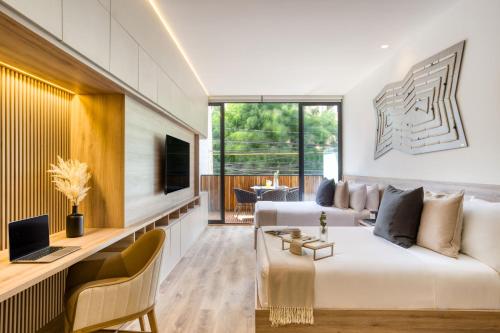 a living room with a white couch and a television at M217 Polanco by Zen Living in Mexico City