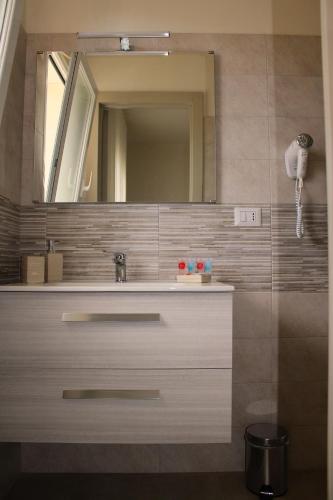 a bathroom with a sink and a mirror at LA BELLA DIMORA in Otranto