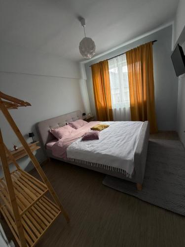a bedroom with a bed and a window at Thaleia Retreat in Ocna-Mureşului