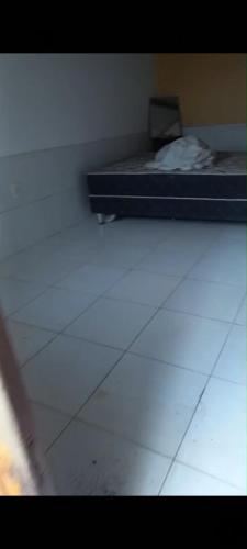 a bedroom with a bed and a white floor at Casa em Bezerros in Bezerros