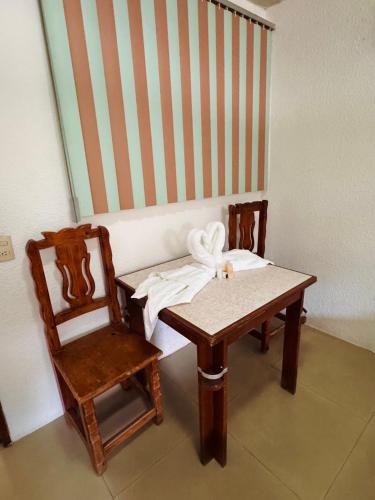 a table and a chair with a towel on it at Hotel Hacienda Real, Villa in Villa del Carbón