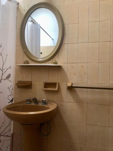 a bathroom with a sink and a mirror on the wall at Hostel Base La Rioja in La Rioja