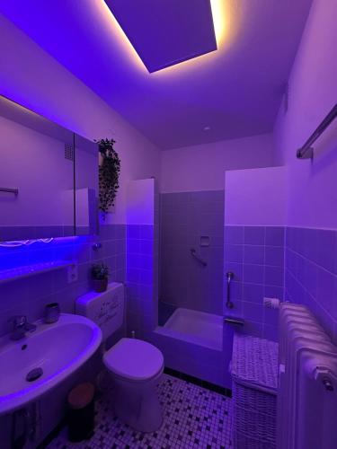 a bathroom with a purple lighting in a bathroom at Bright & Spacious 1BR Apartment in Bielefeld