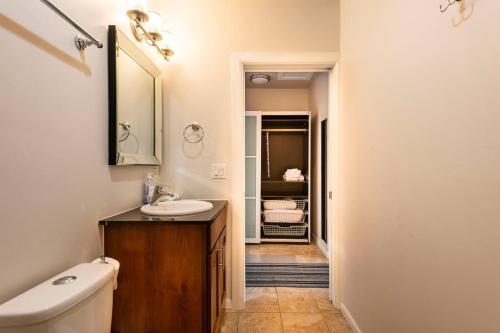 a bathroom with a sink and a toilet and a mirror at Studio nr Town Lake and E6th w Balcony by Austin Vacay in Austin