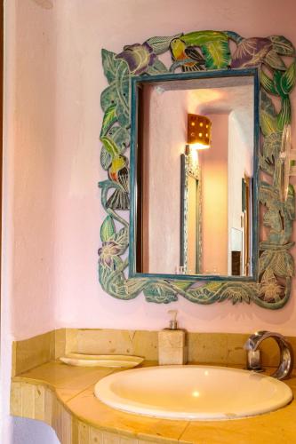 a bathroom with a sink and a mirror at Villas Paraiso Valle de Bravo in Valle de Bravo
