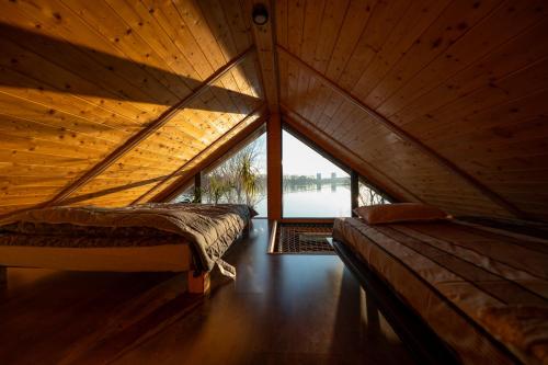 a room with two beds in a wooden attic at Danube Retreat in Belgrade